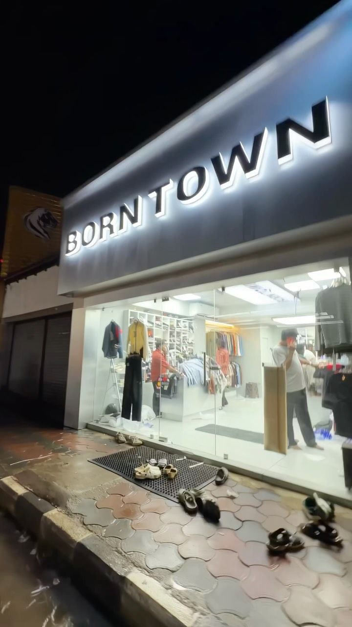 Borntown store front lit up at night, near SB College, Changanassery