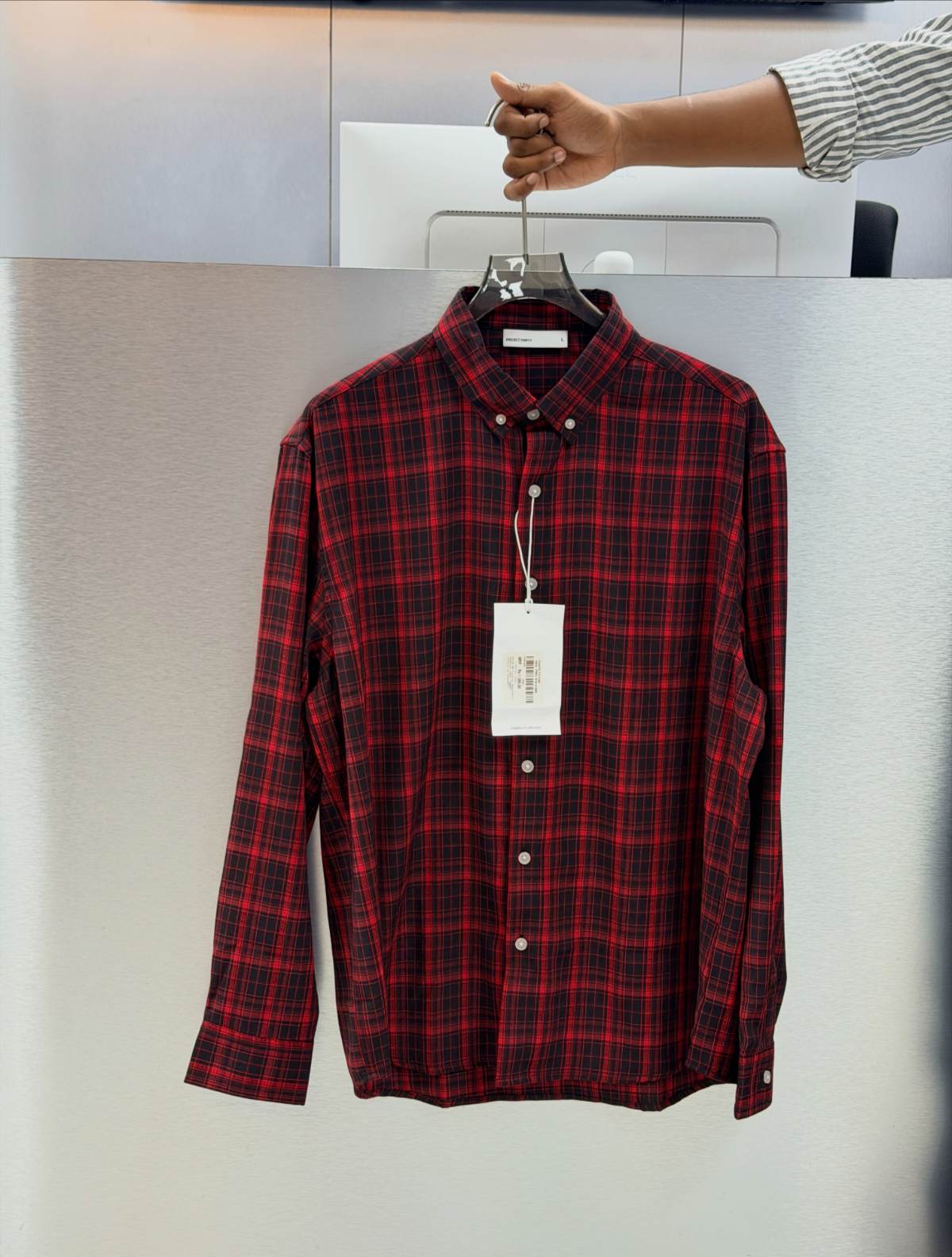 Red check flannel shirt on a hanger